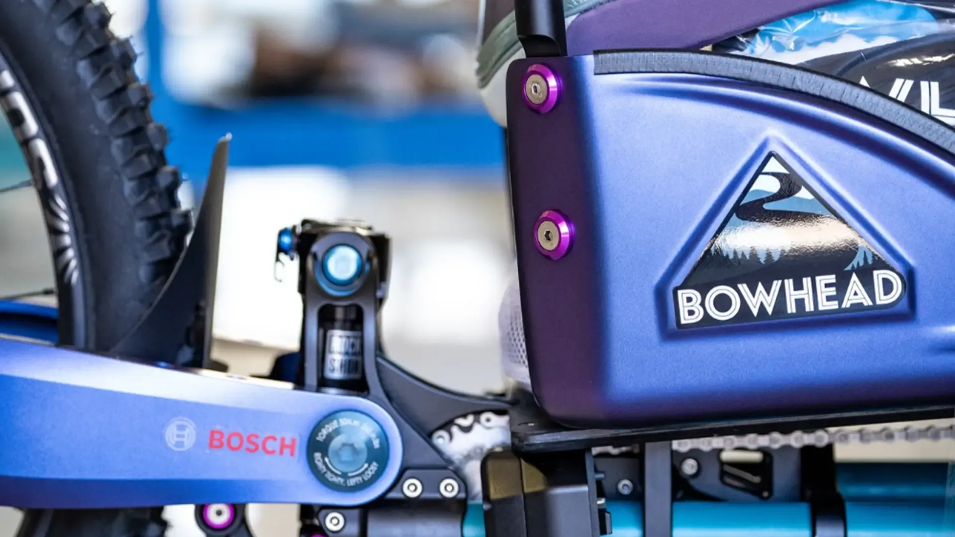 Close-up of Bowhead mobility device by a not-for-profit helping disabled people access the outdoors, with Bosch part, blue frame, logo visible.