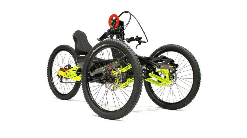 Adaptive four-wheeled off-road handcycle with large tyres and neon frame, enabling disabled access to outdoor activities and nature.