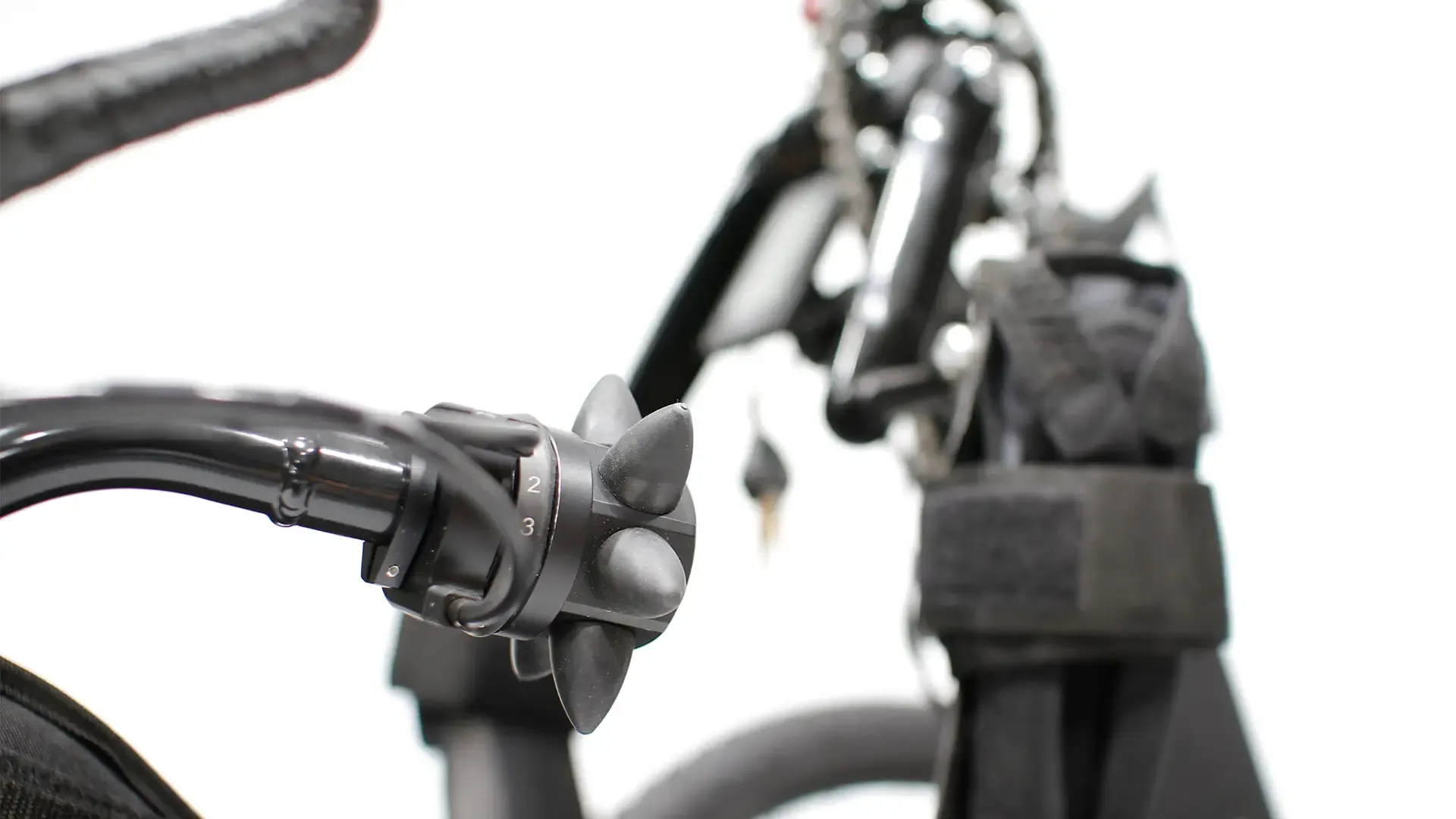 Accessible cycling for disabled people: close-up of bike handlebar with twist shifter, promoting inclusive outdoor activities.